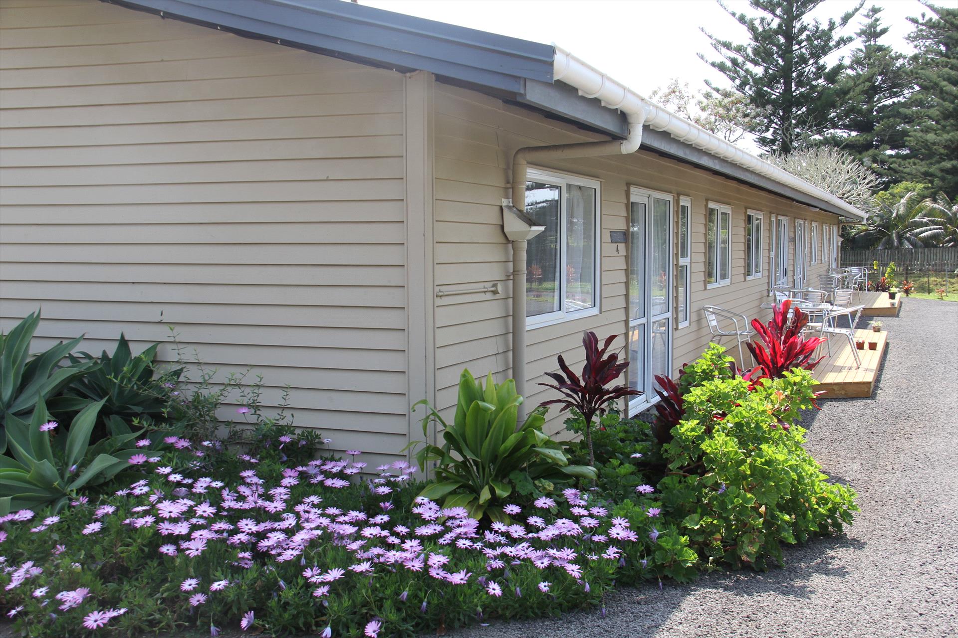 Saints Holiday Apartments exterior bordered by flowering gardens