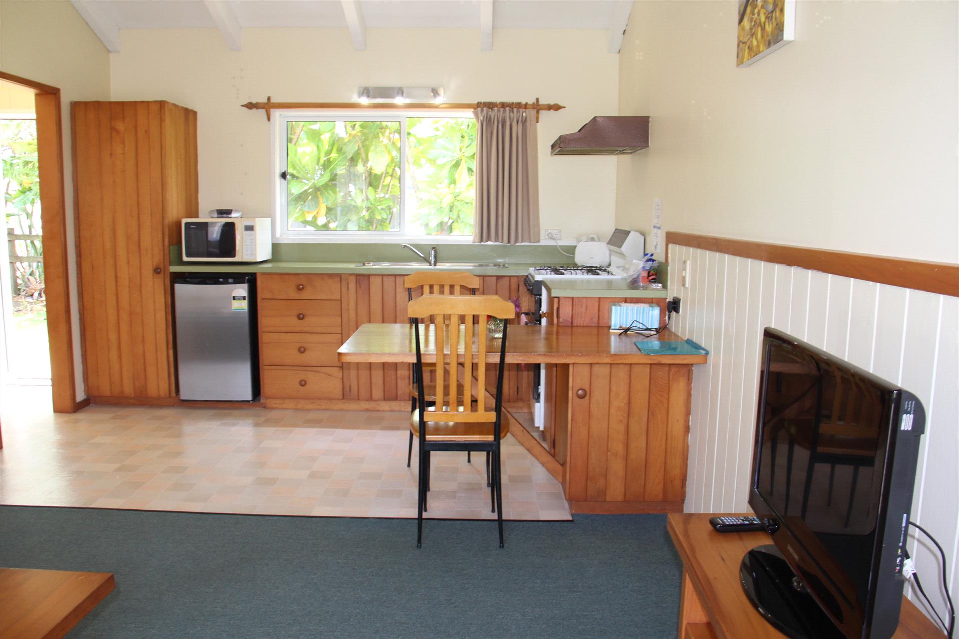 Self-contained timber kitchen and dining space